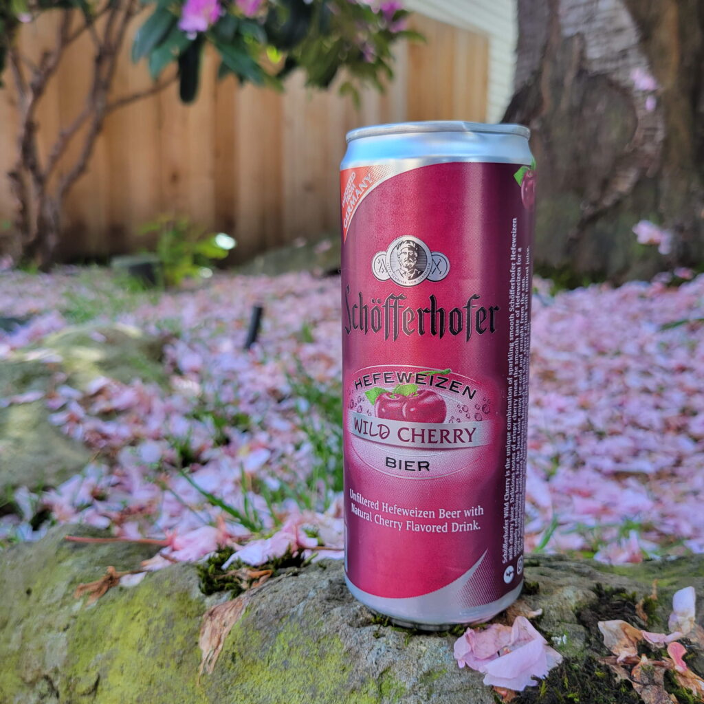 can in front of cherry blossom